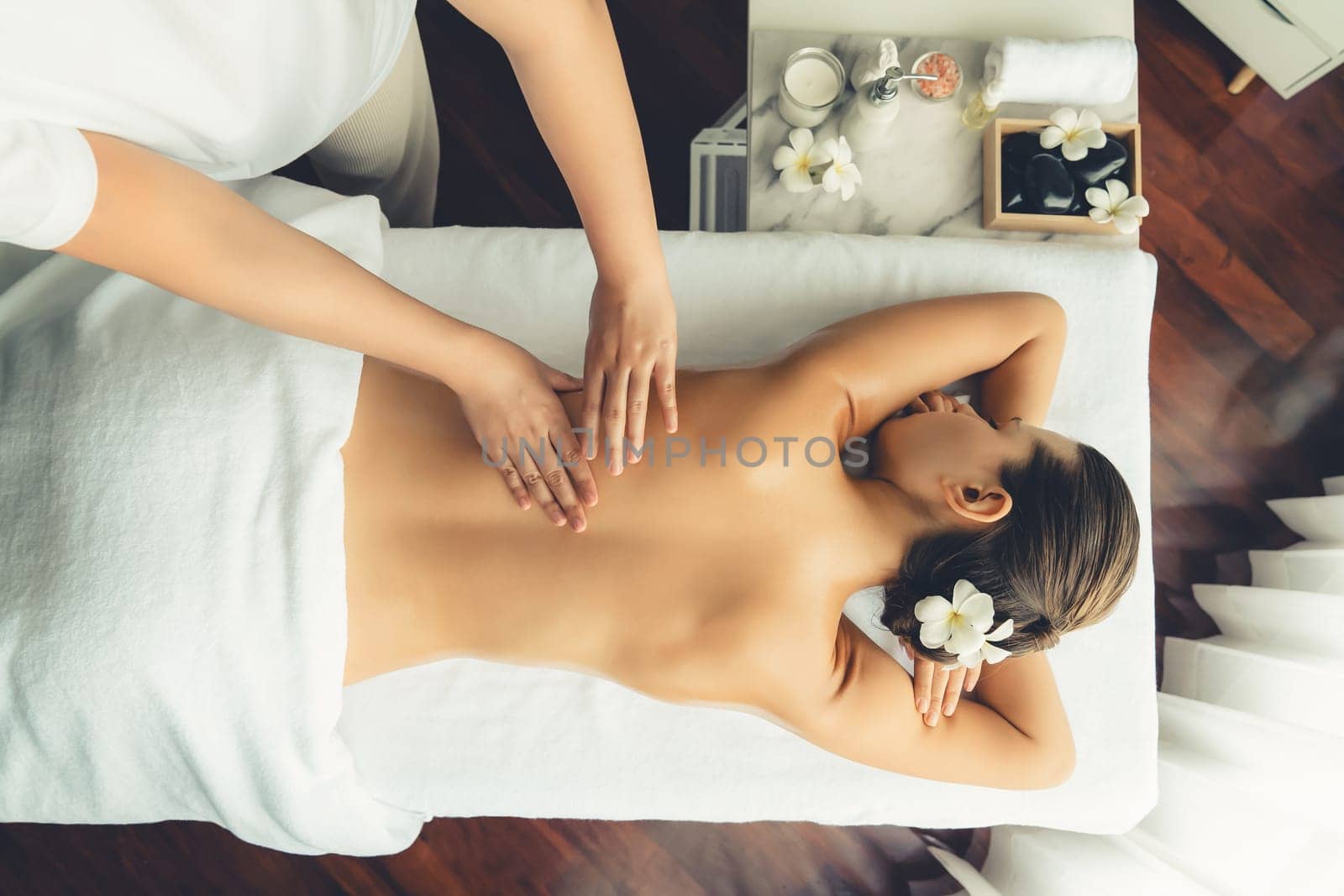 Caucasian woman customer enjoying relaxing anti-stress massage. Quiescent by biancoblue