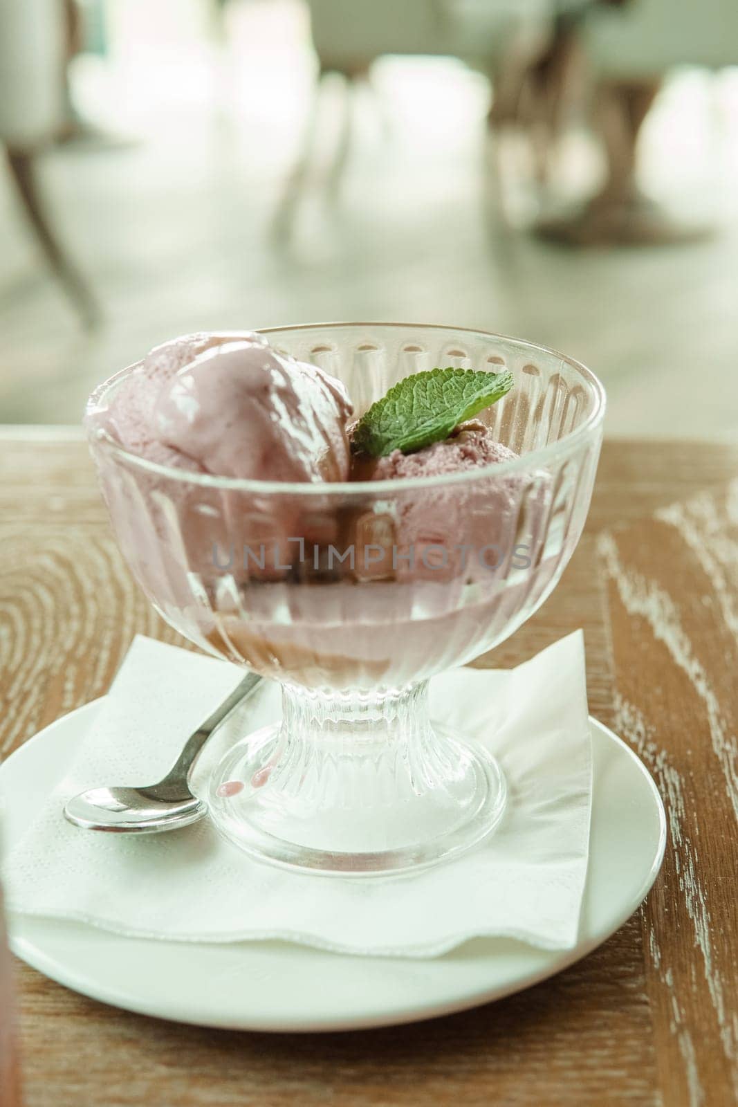 Closeup of cherry granita in glass bowl, on color wooden background by Annu1tochka