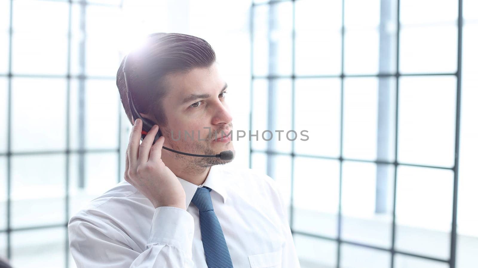 Male office worker close-up in the office working.