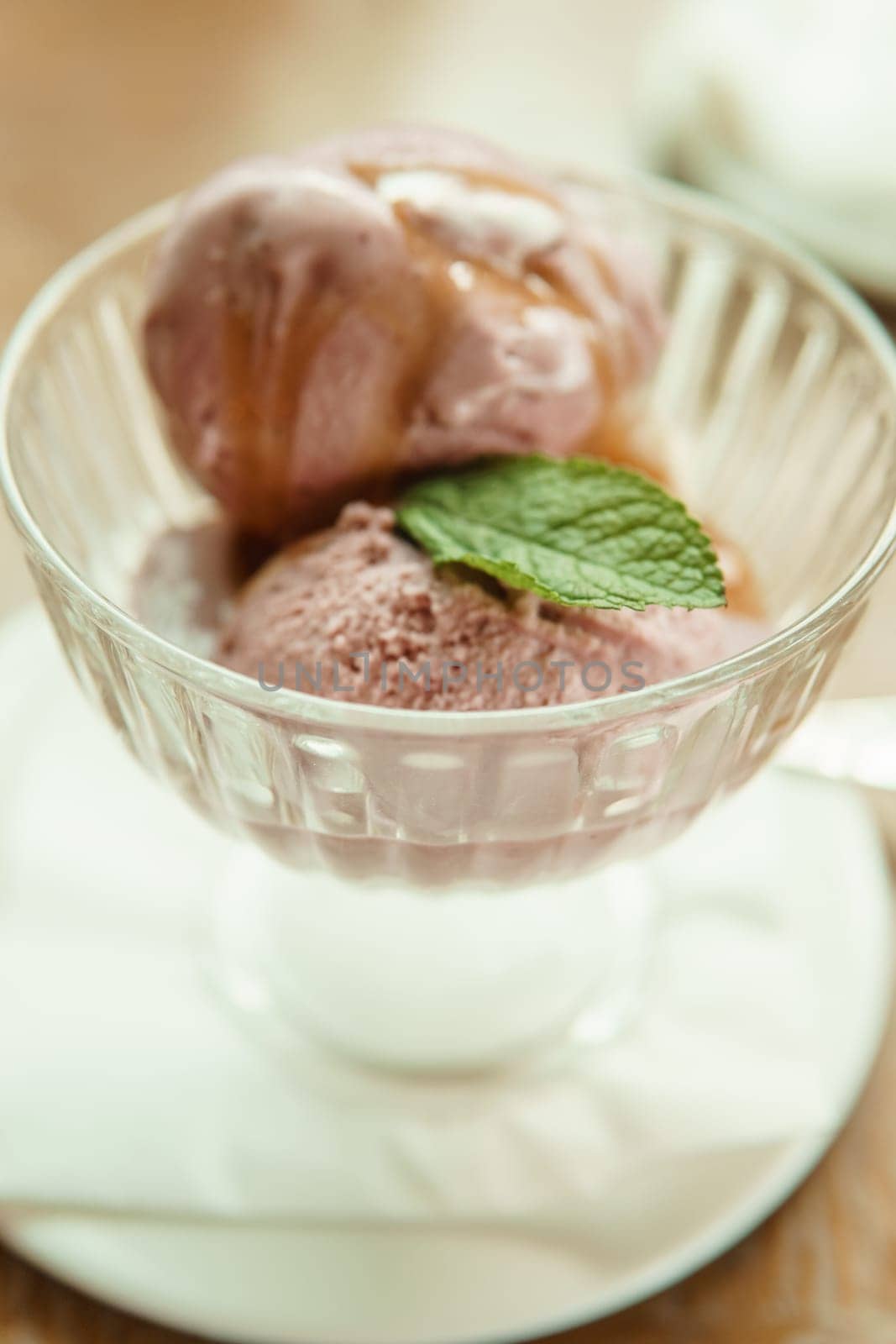 Closeup of cherry granita in glass bowl, on color wooden background by Annu1tochka