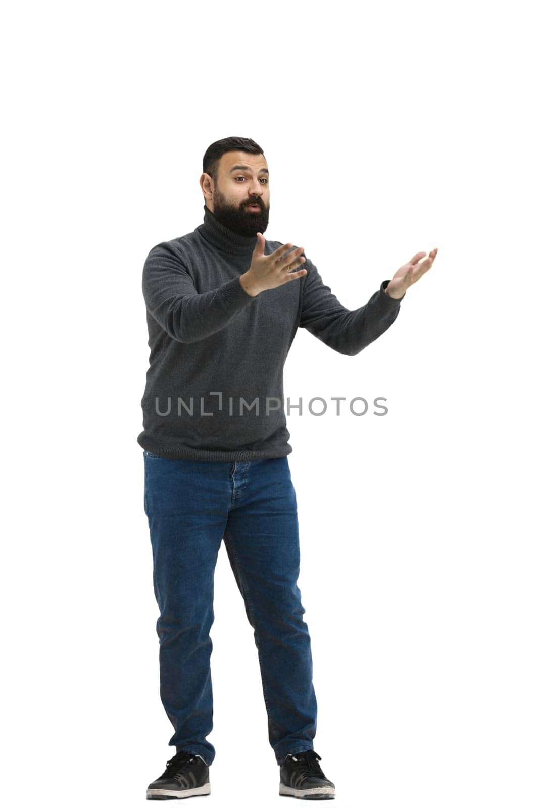 A man, full-length, on a white background, spreads his arms.