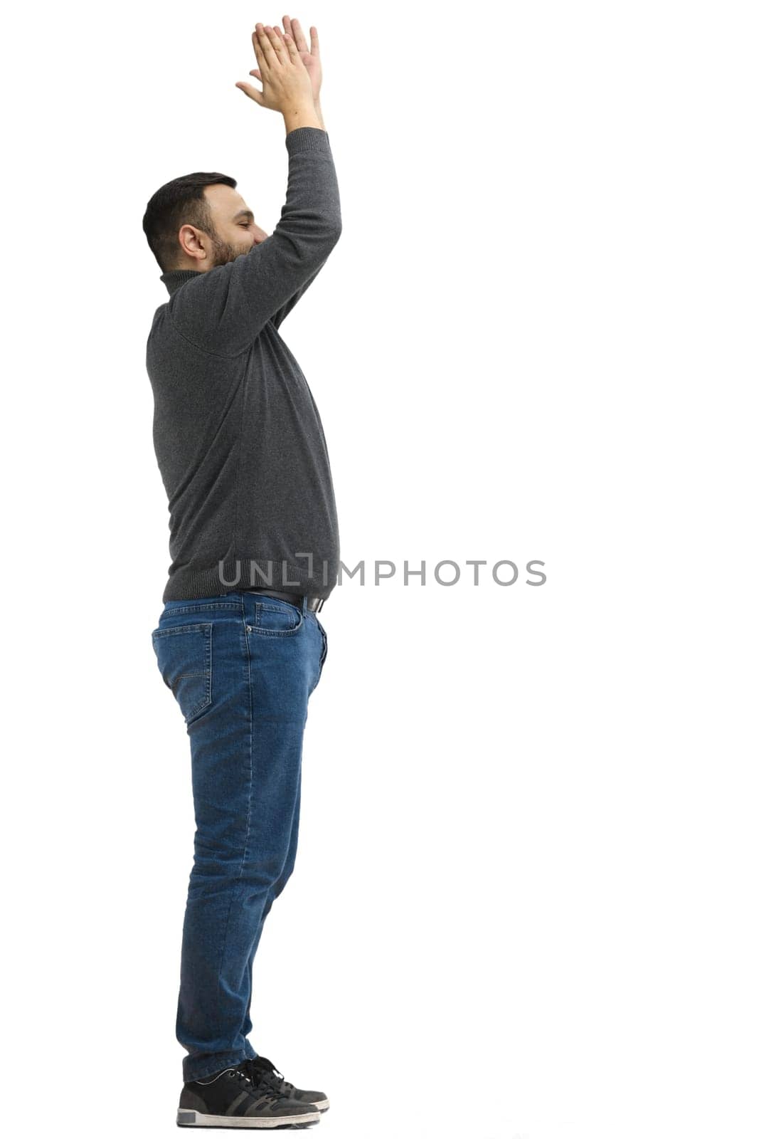 A man, full-length, on a white background, claps.