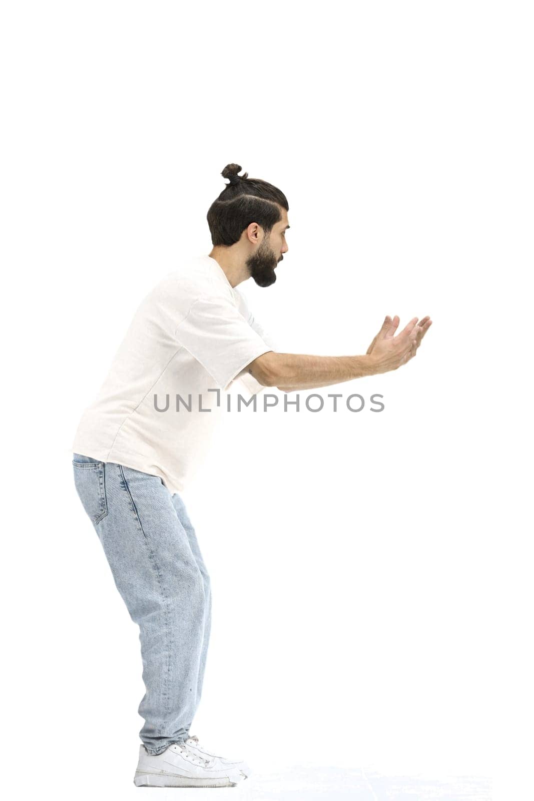 A man, full-length, on a white background, spreads his arms.