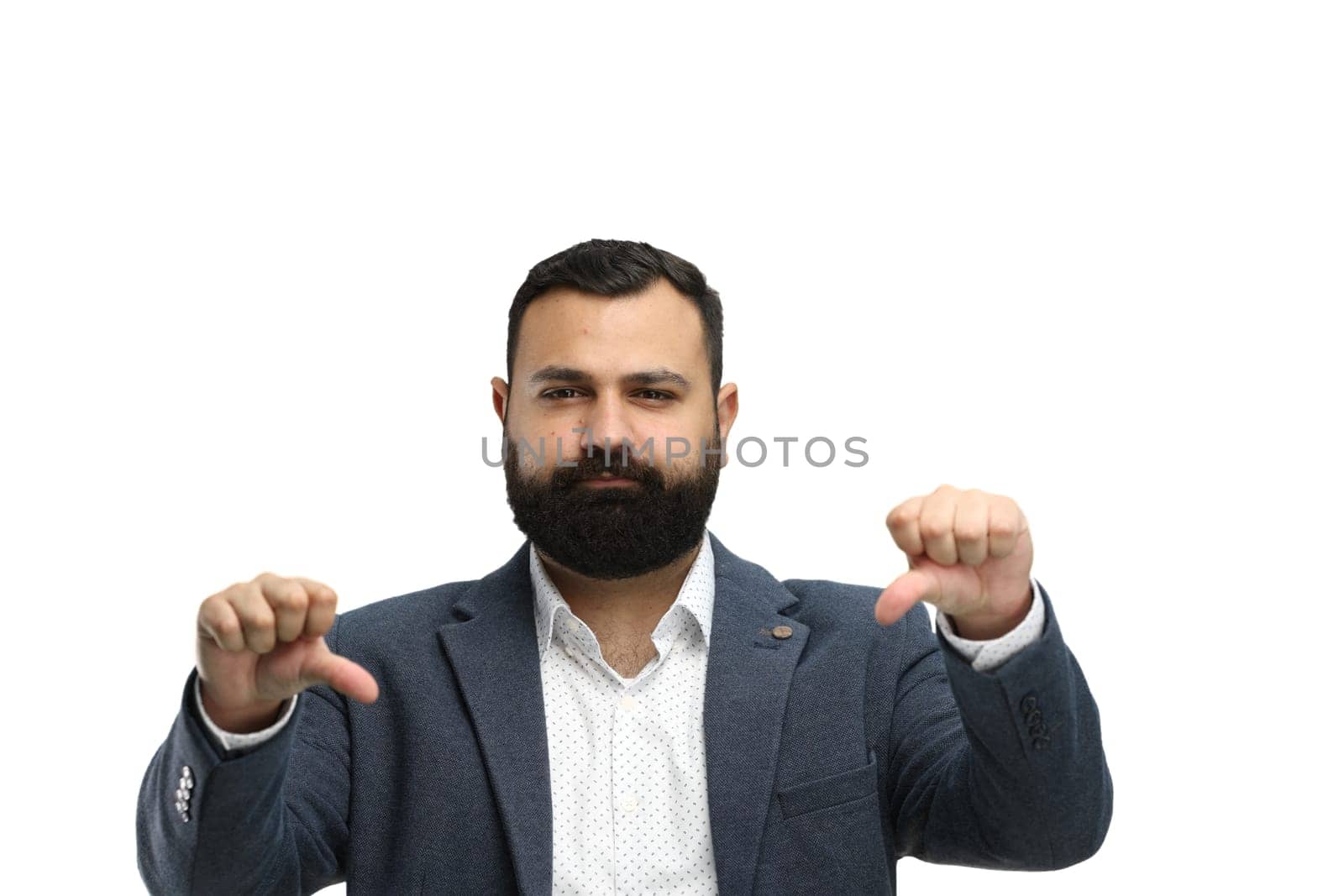 A man, close-up, on a white background, shows his thumbs down.