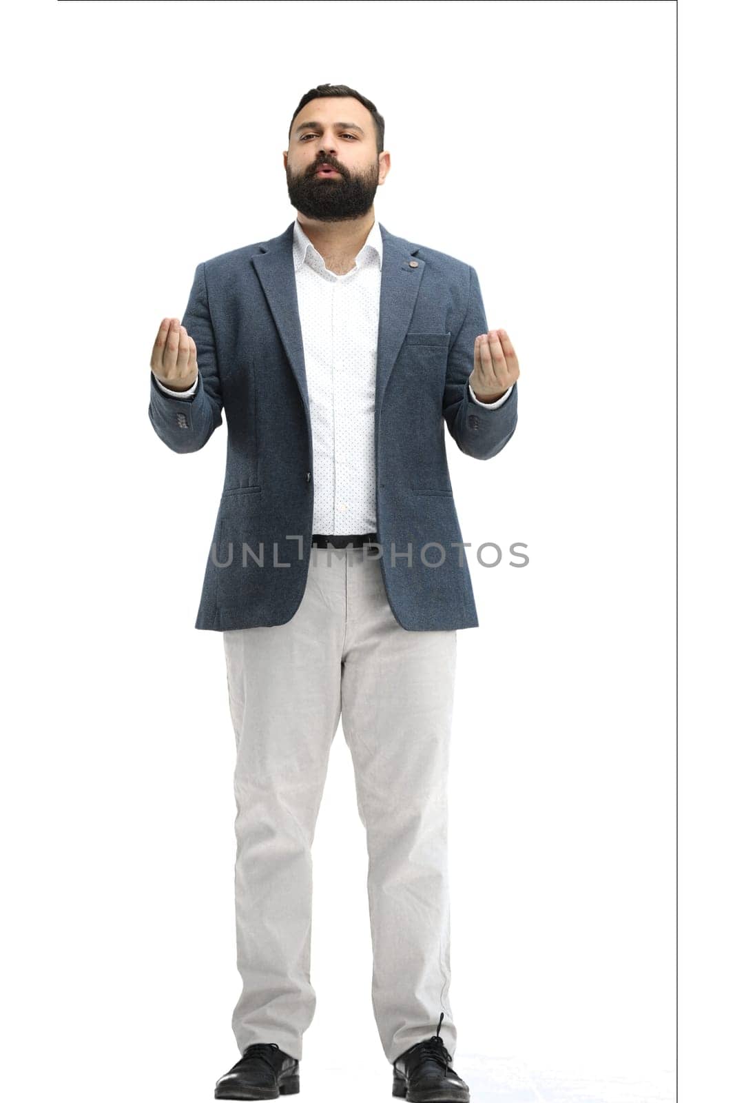 A man, full-length, on a white background, meditating.