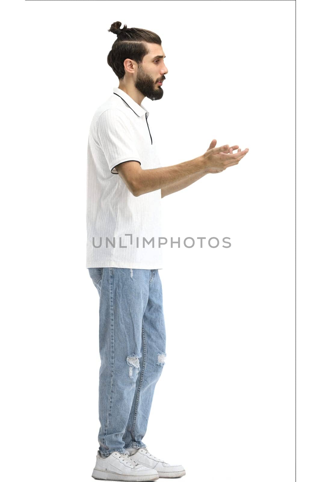 A man, full-length, on a white background, gestures.