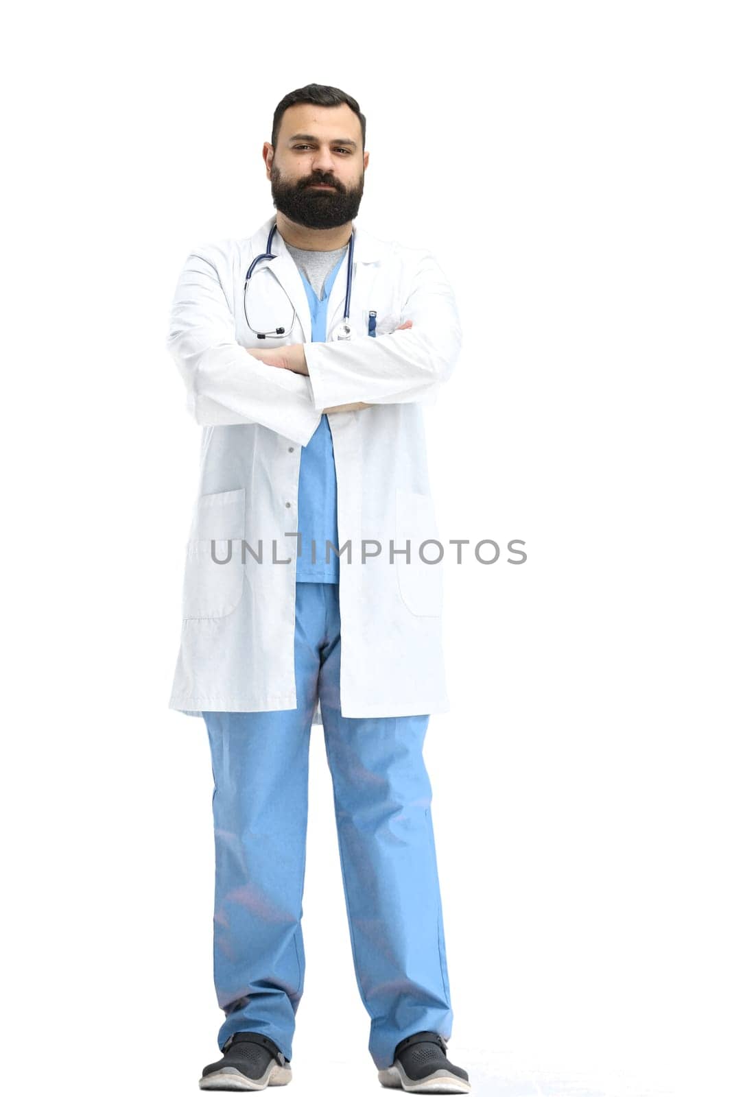 The male doctor, full-length, on a white background, crossed his arms.