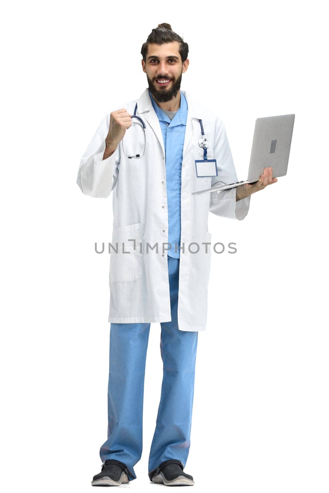 Male doctor, full-length, on a white background, with a laptop.