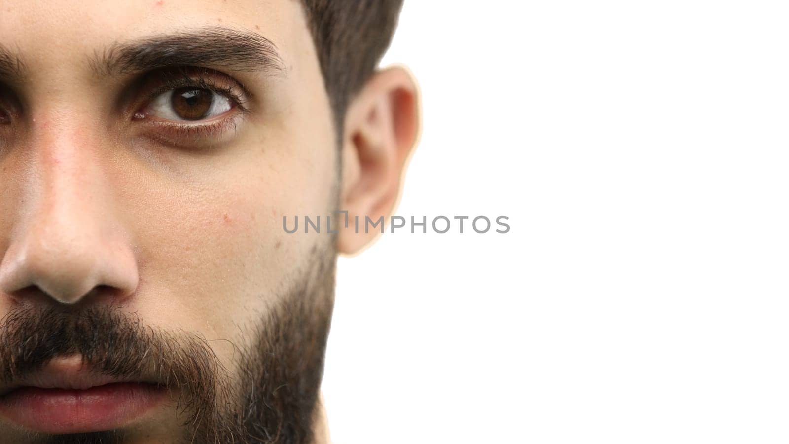 Man's face, close-up, on a white background.