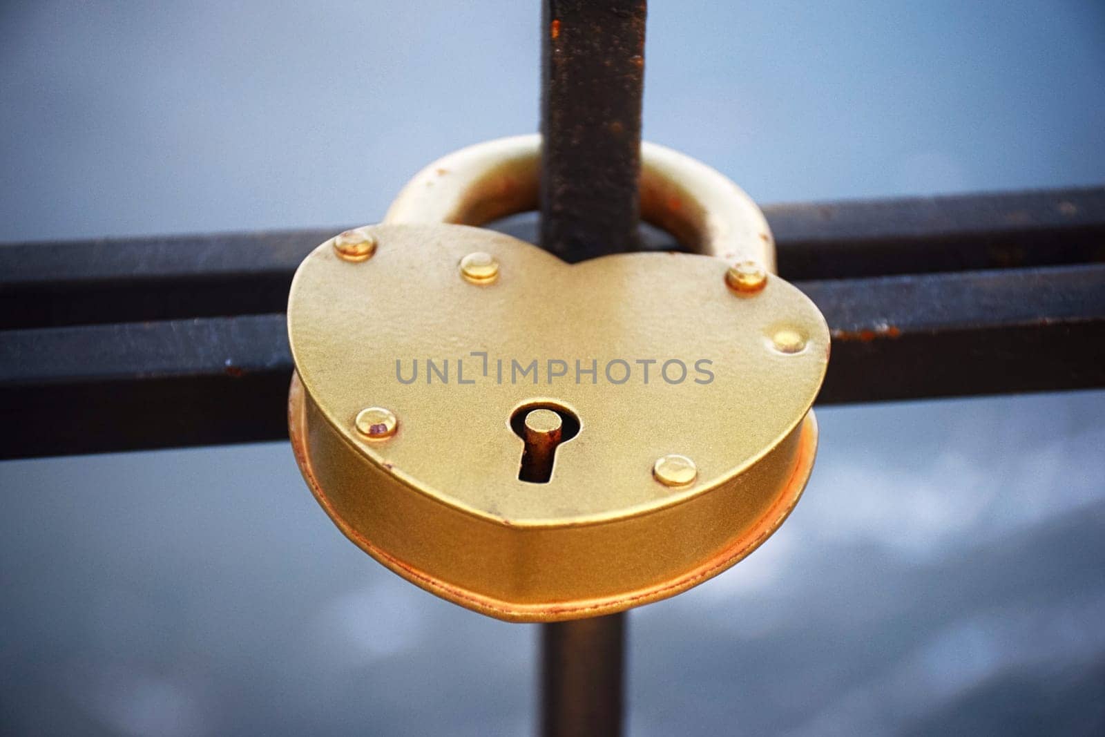A heart shaped lock connected to other locks near Westminster bridge, Big Ben defocused by IaroslavBrylov
