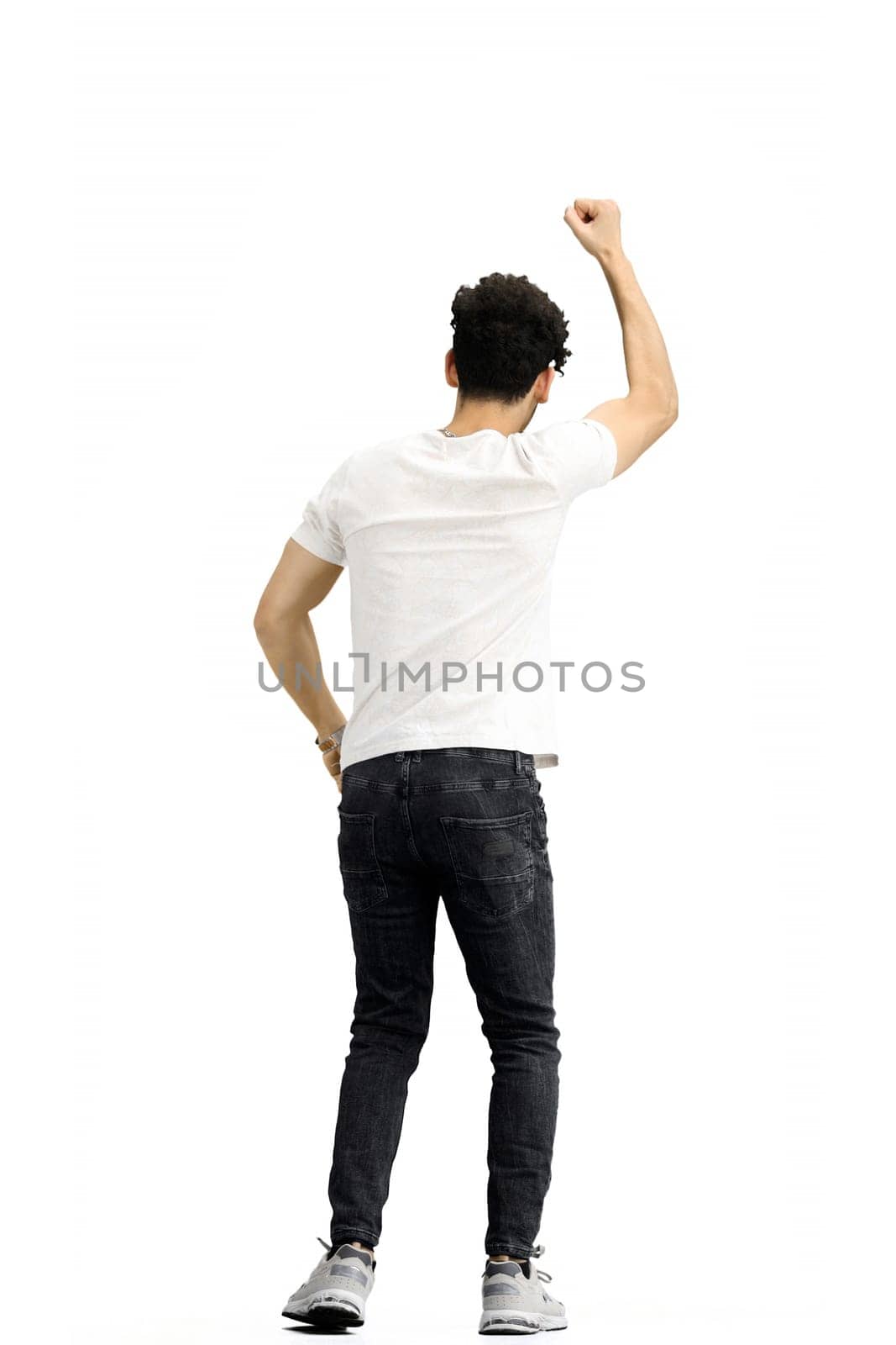 A man, on a white background, in full height, his hands raised up.