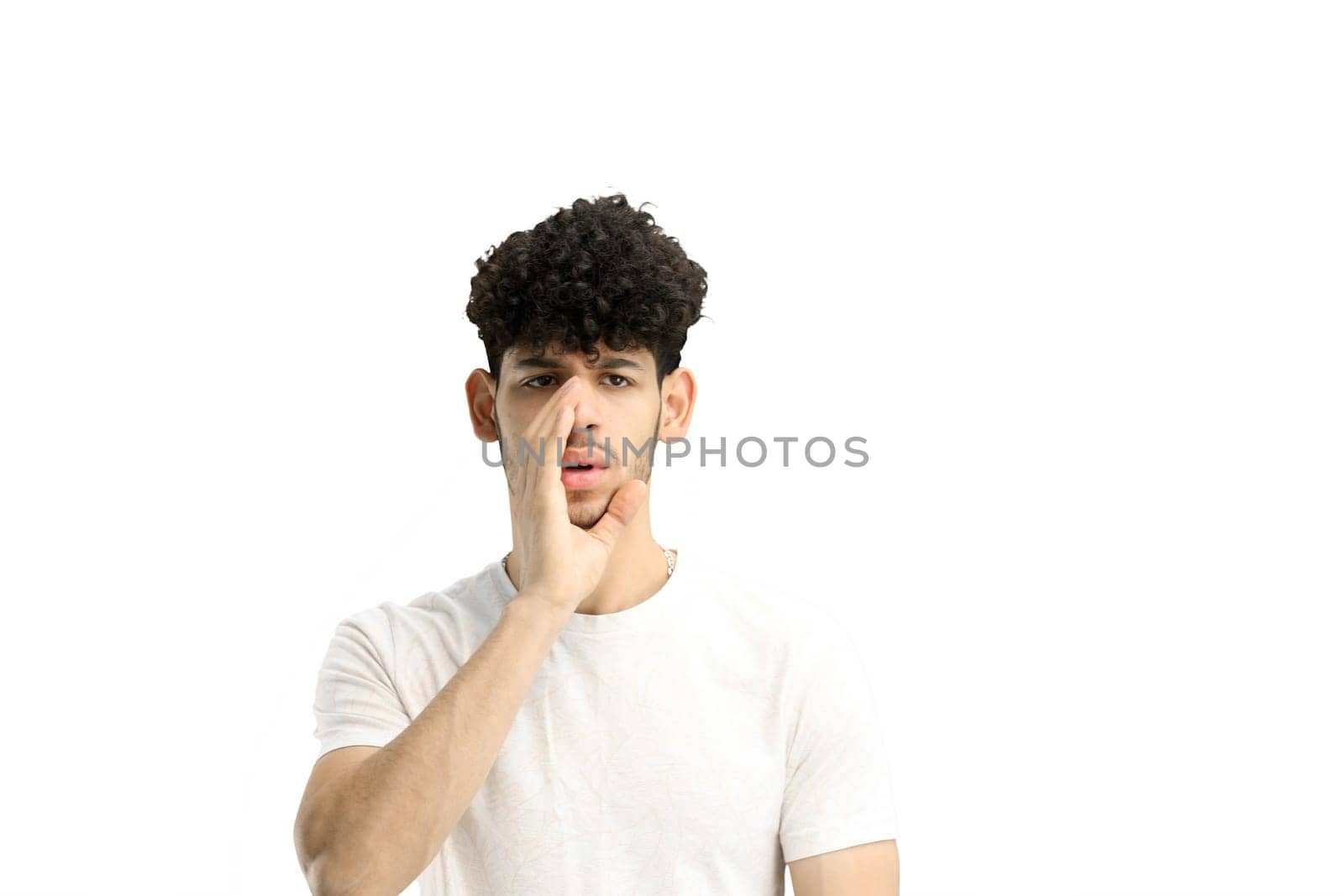 A man, on a white background, in close-up, tells a secret.