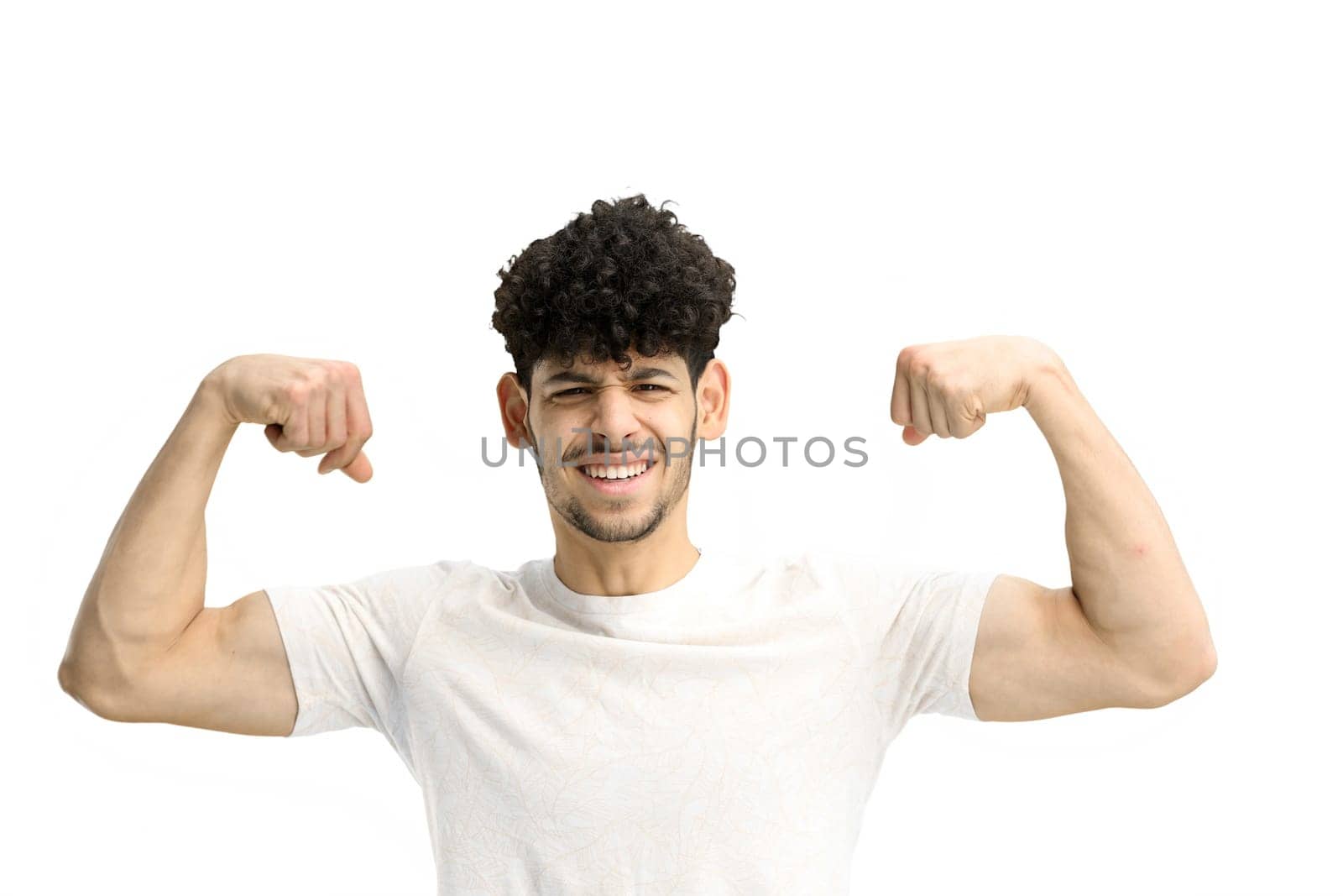 A man, on a white background, close-up, shows strength.