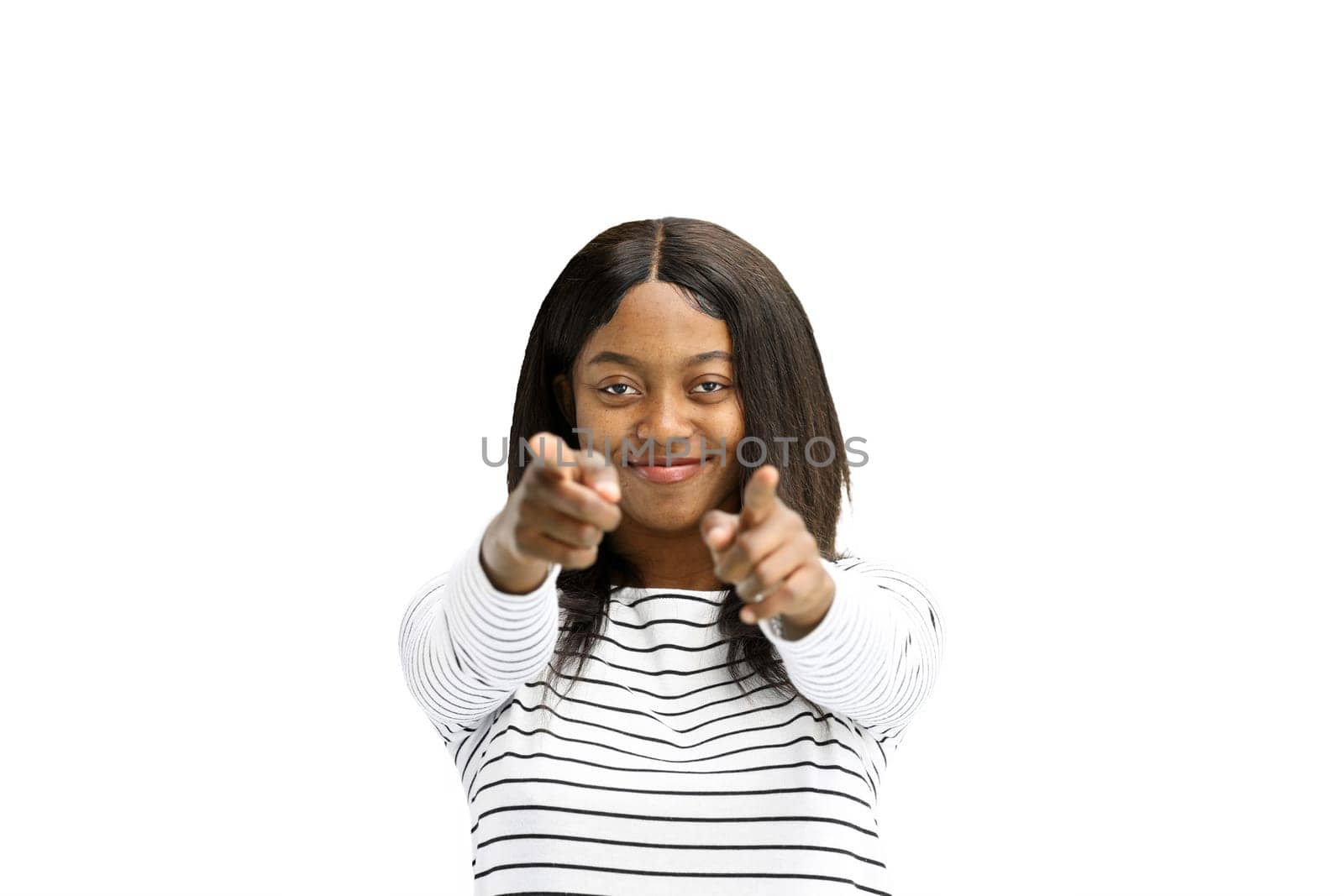 A woman, on a white background, in close-up, points forward.