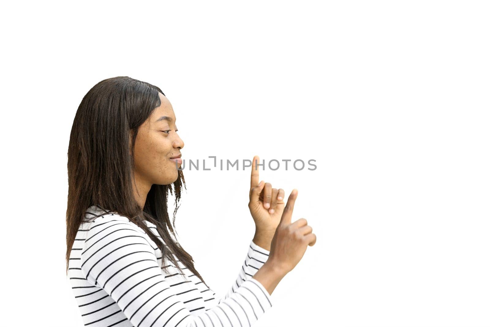 A woman, on a white background, in close-up, points to the side.