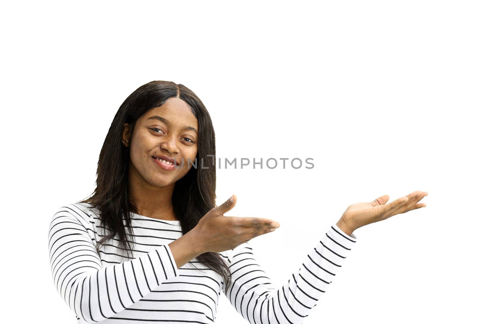 A woman, on a white background, in close-up, points to the side.