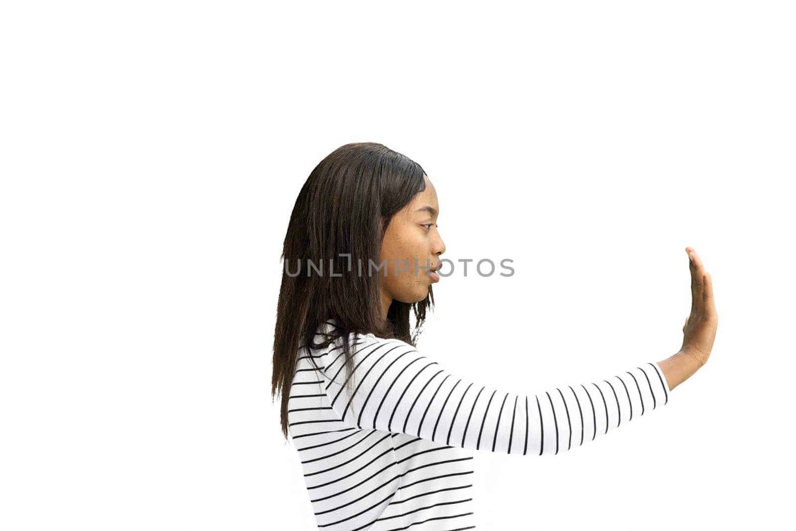 A woman, on a white background, in close-up, shows a stop sign.