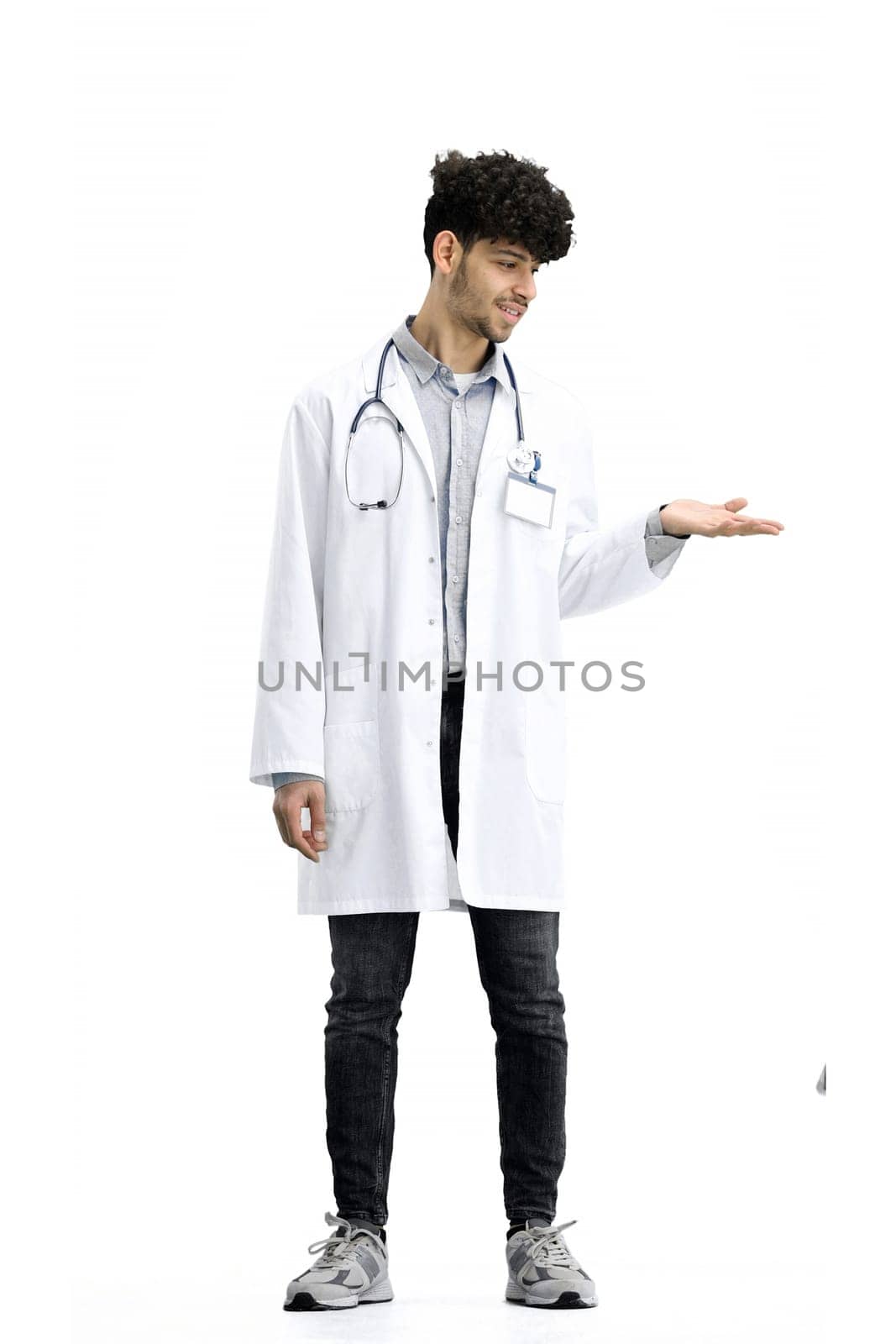 The male doctor, full-length, on a white background, points to the side by Prosto