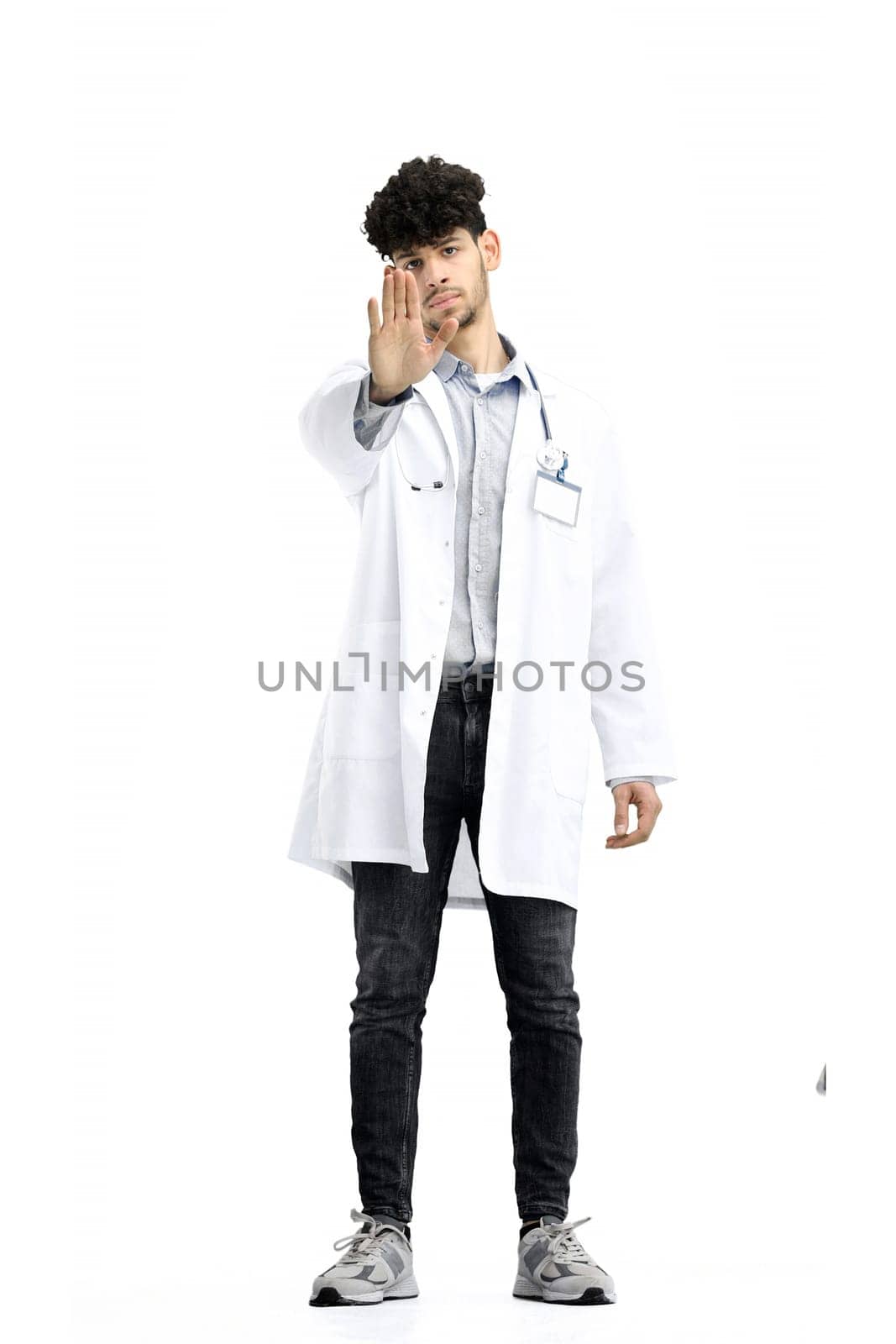 Male doctor, full-length, on a white background, shows a stop sign by Prosto