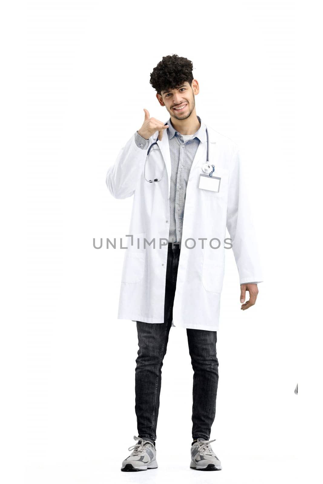 Male doctor, full-length, on a white background, shows a call sign by Prosto