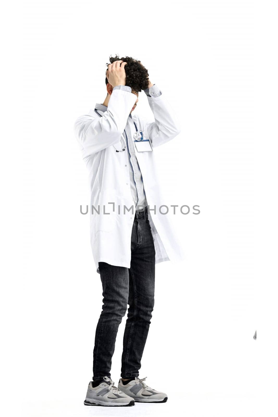 The male doctor, in full height, on a white background, clutched his head by Prosto