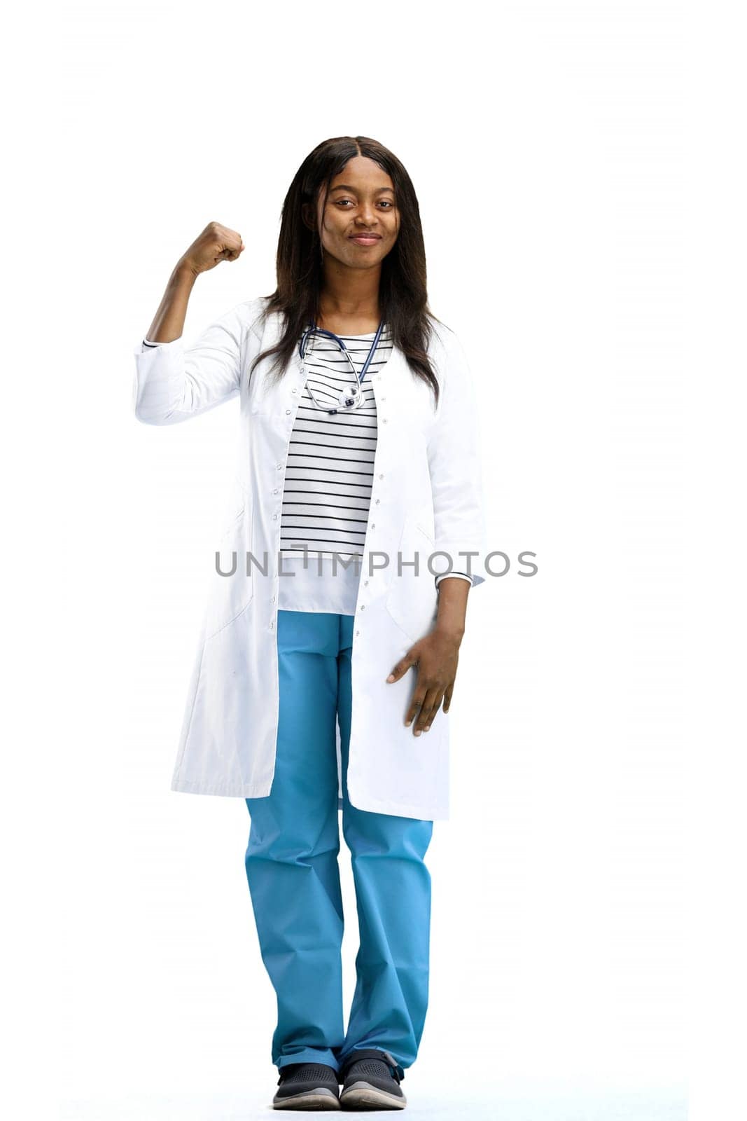 Female doctor, full-length, on a white background, shows strength.