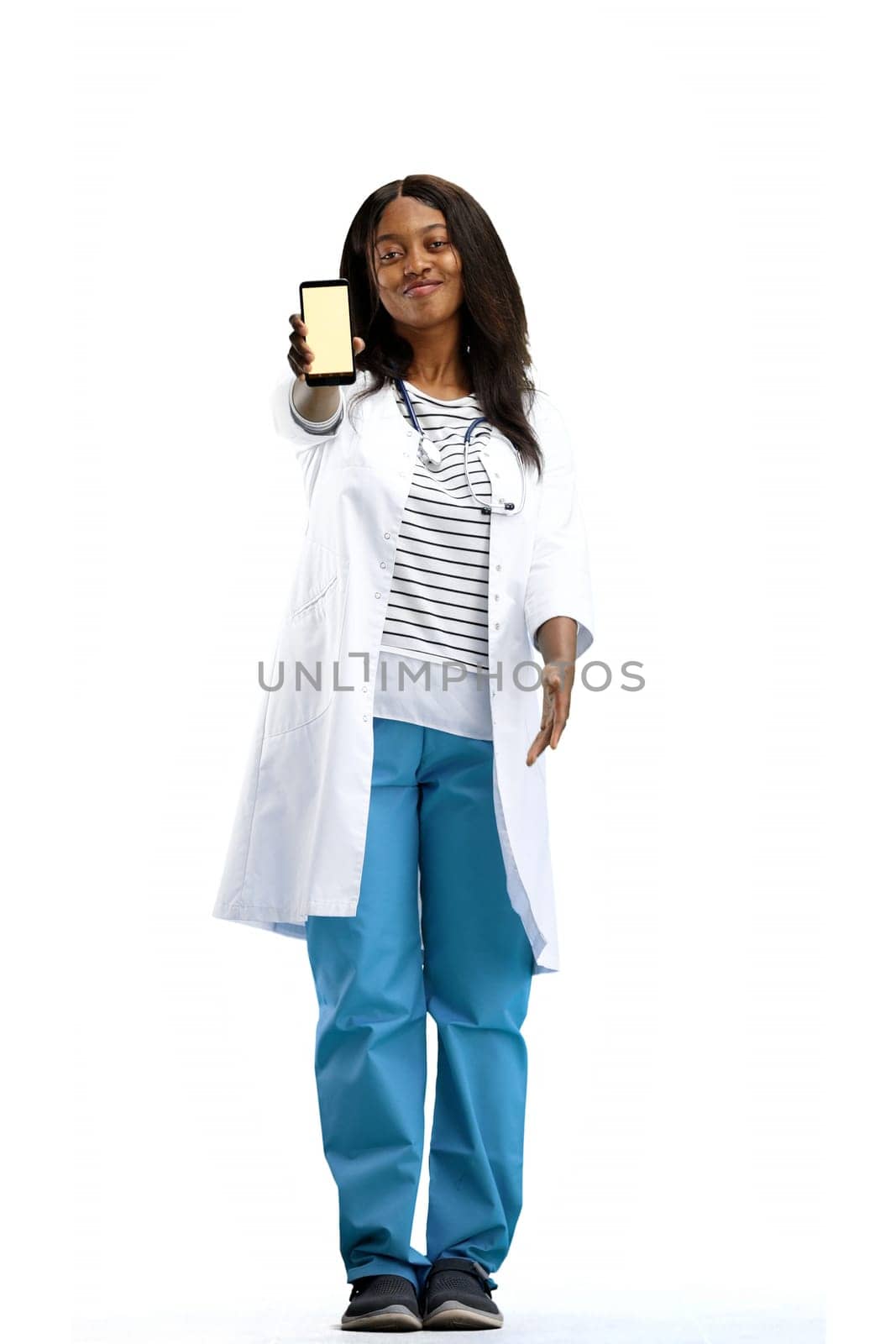 Female doctor, full-length, on a white background, with a phone.