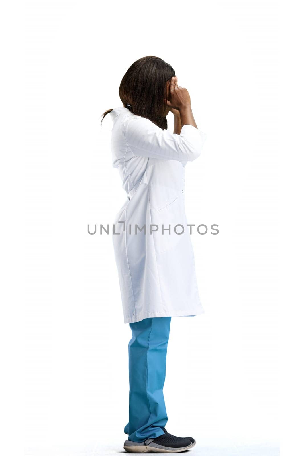 Female doctor, full-length, on a white background, tired.