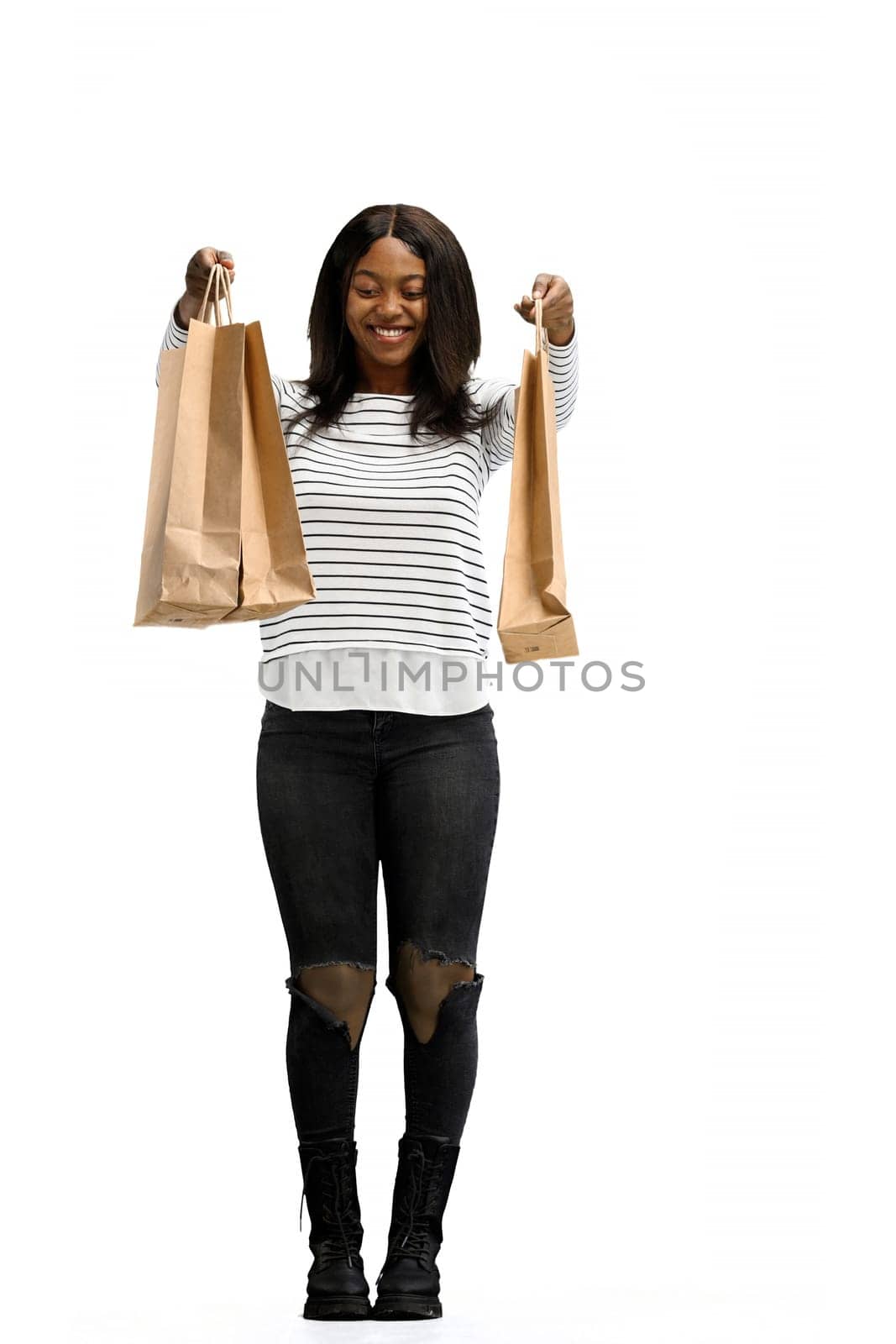 A woman, full-length, on a white background, with bags.