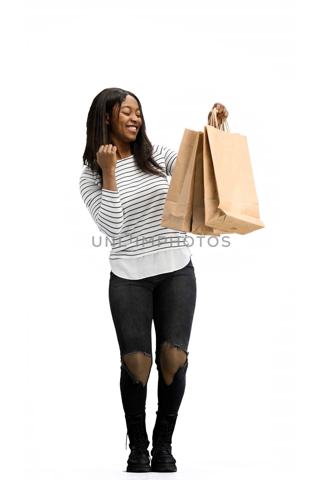 A woman, full-length, on a white background, with bags.