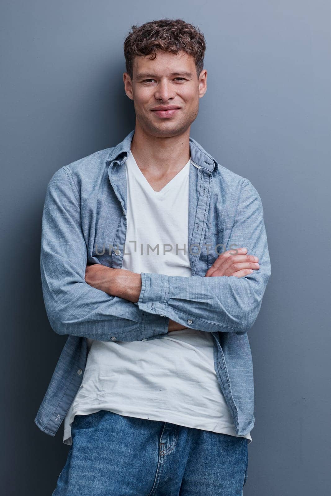 portrait of a young man on a gray background.