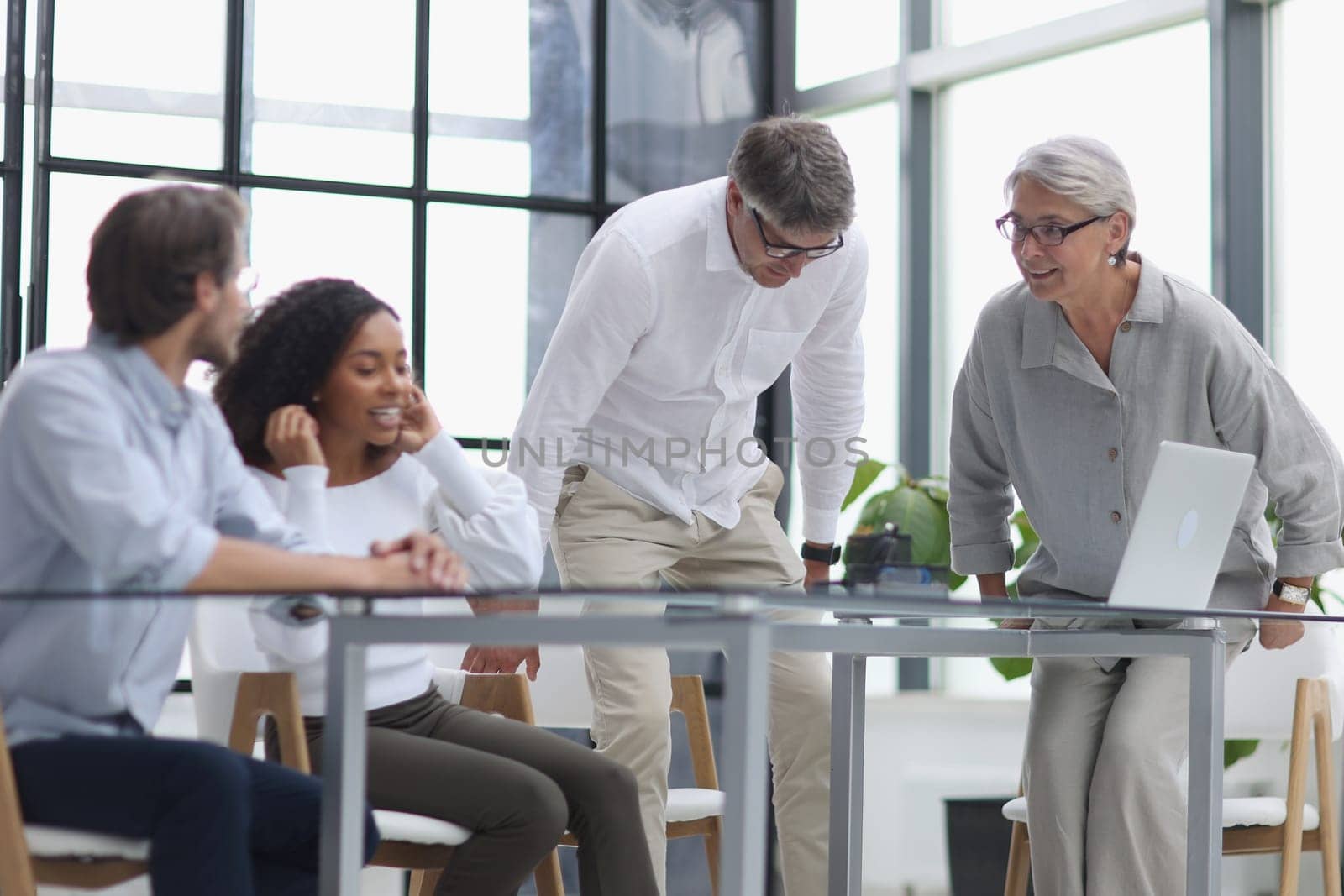 Negotiations in the office. Cheerful businesswoman shaking hands with colleague