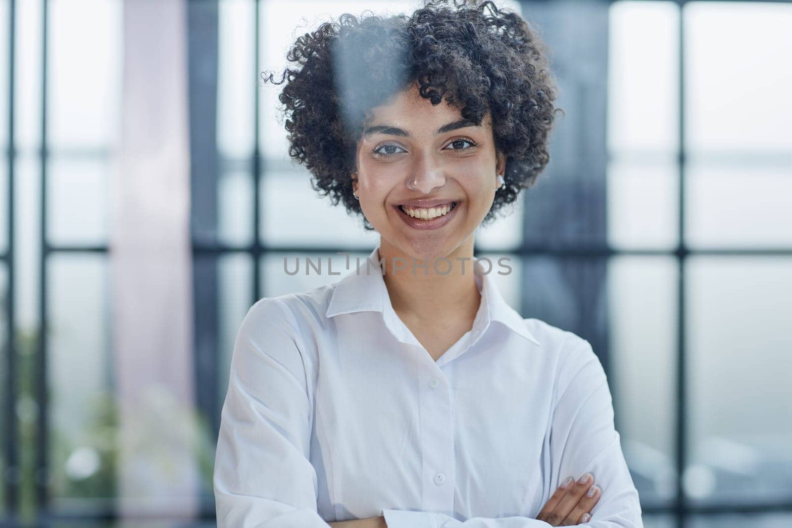 business woman looks admiringly into the distance through the glass at modern office