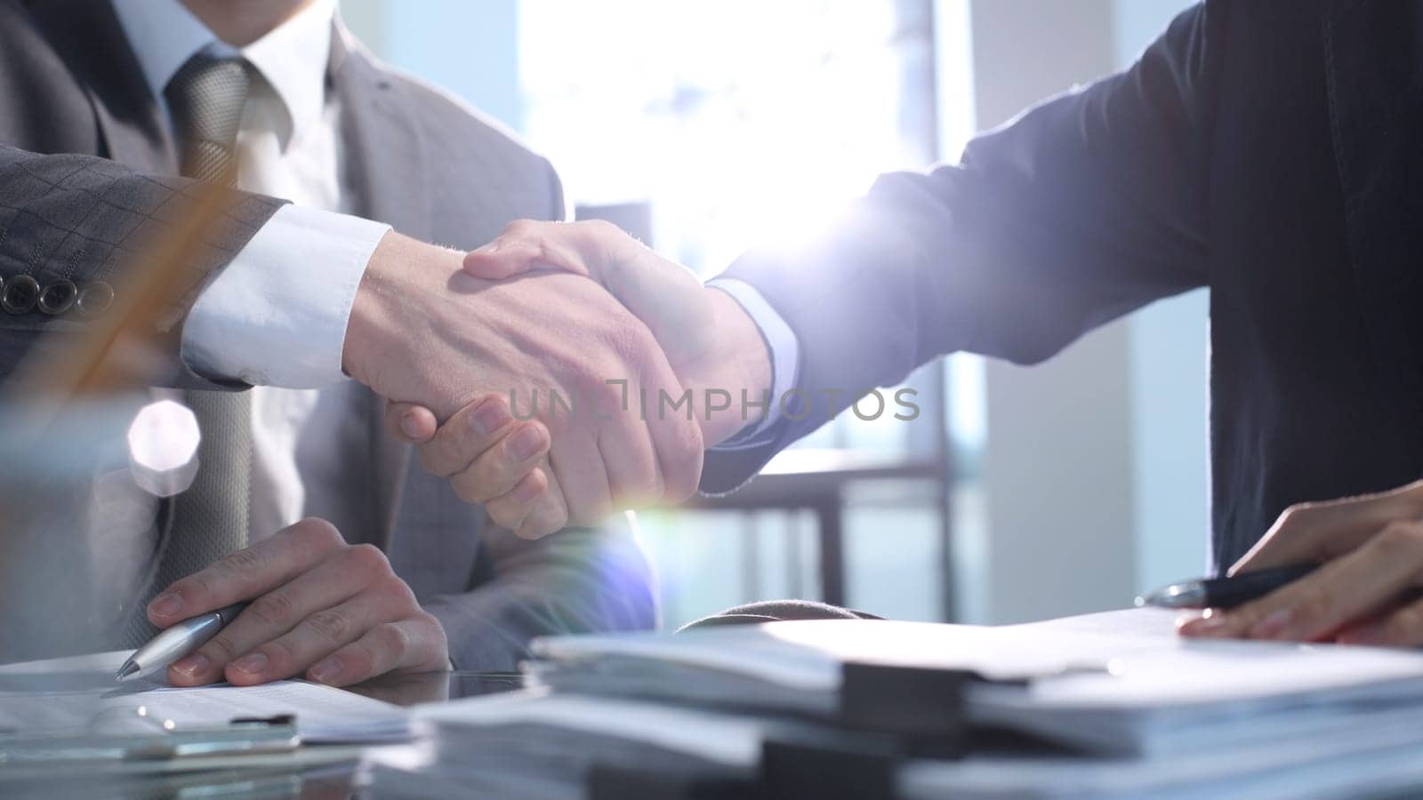 Signing documents at a meeting, business handshake by Prosto