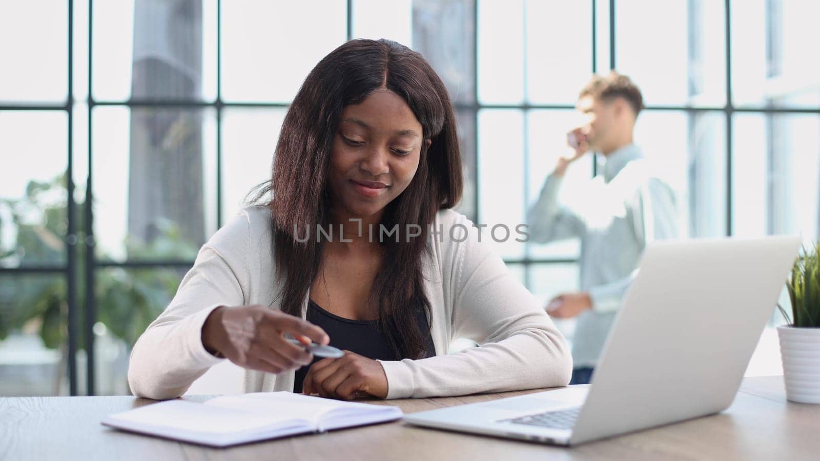 female employee or a businesswoman using a laptop in a modern office by Prosto