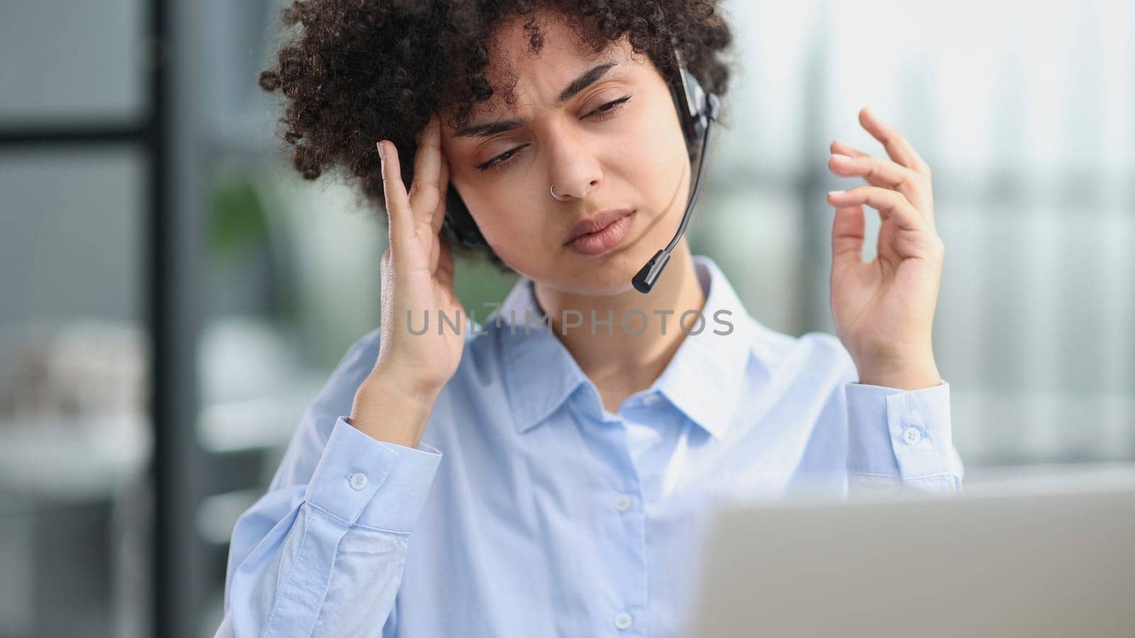 girl in a modern office working in a call center smiling.