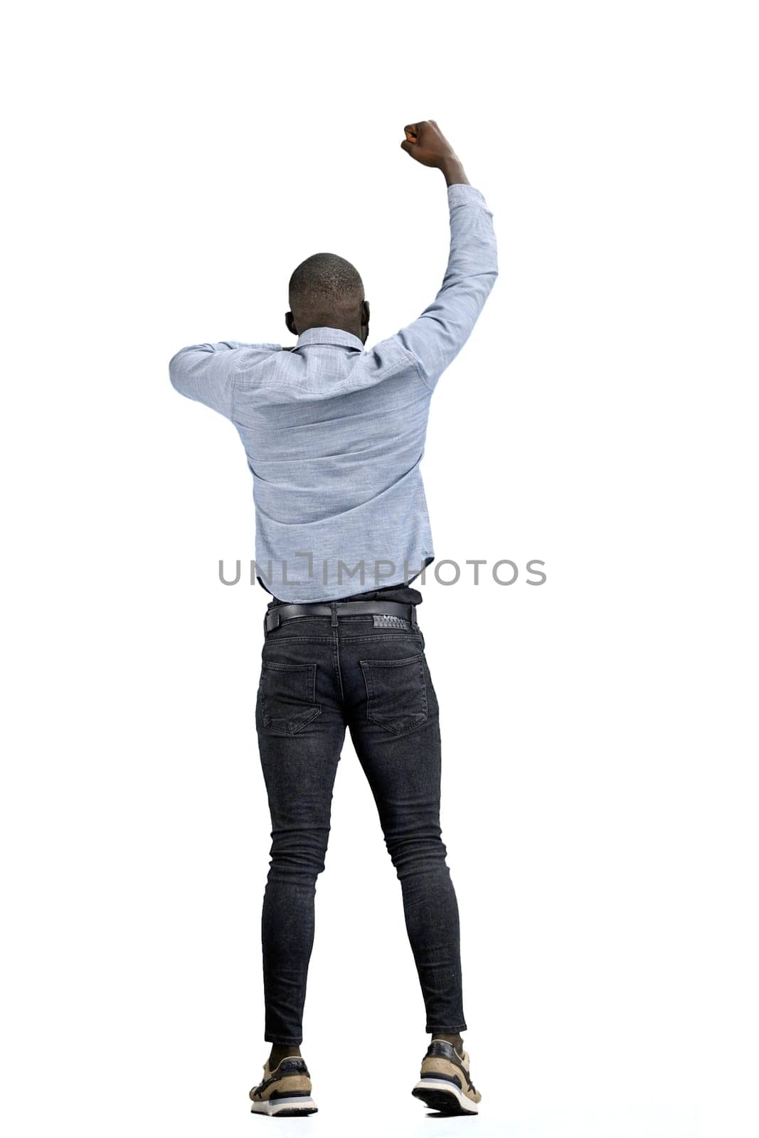 A man, full-length, on a white background, rejoices.