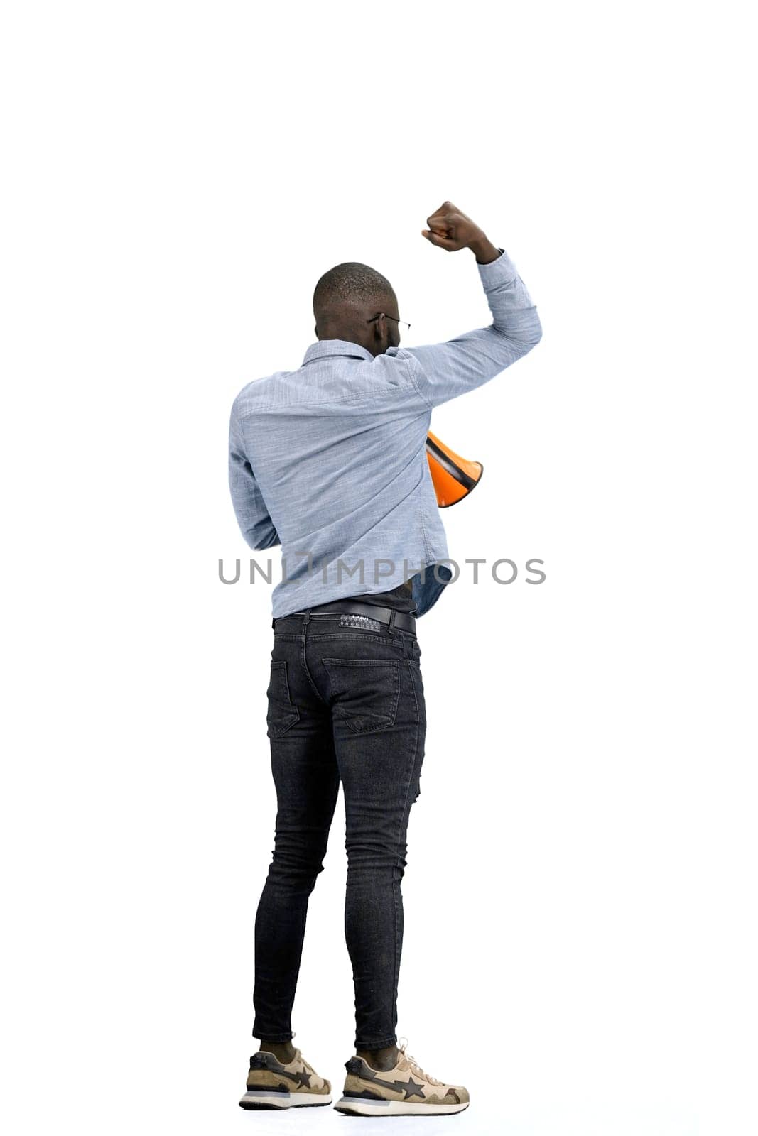 A man, full-length, on a white background, with a megaphone.