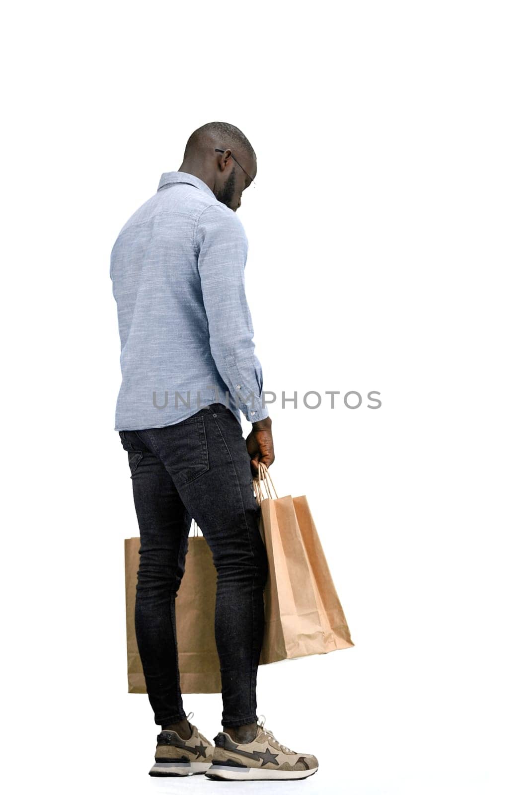 A man, full-length, on a white background, with bags by Prosto