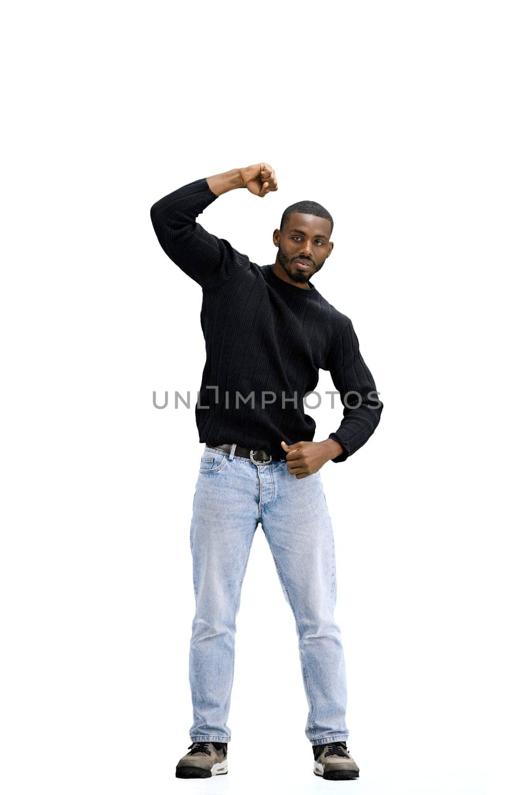 A man, full-length, on a white background, raises his hand up.