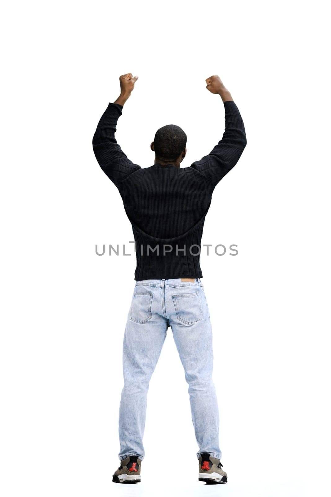 A man, full-length, on a white background, raised his hands up.