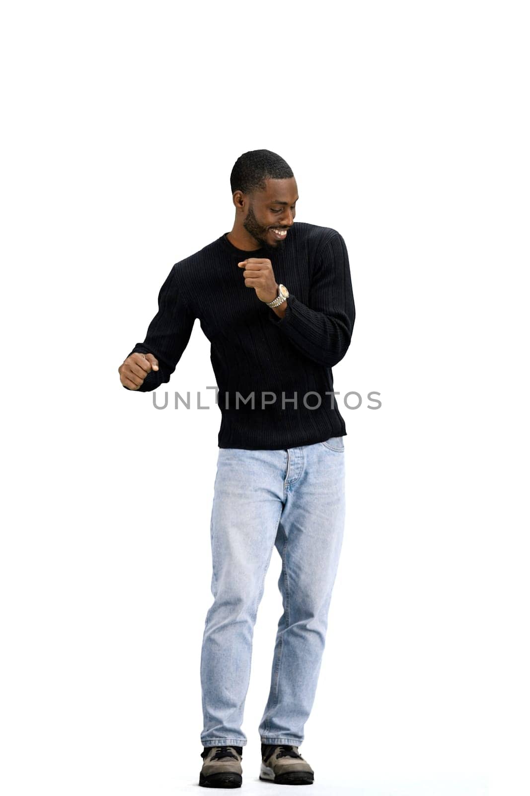 A man, full-length, on a white background, dancing.