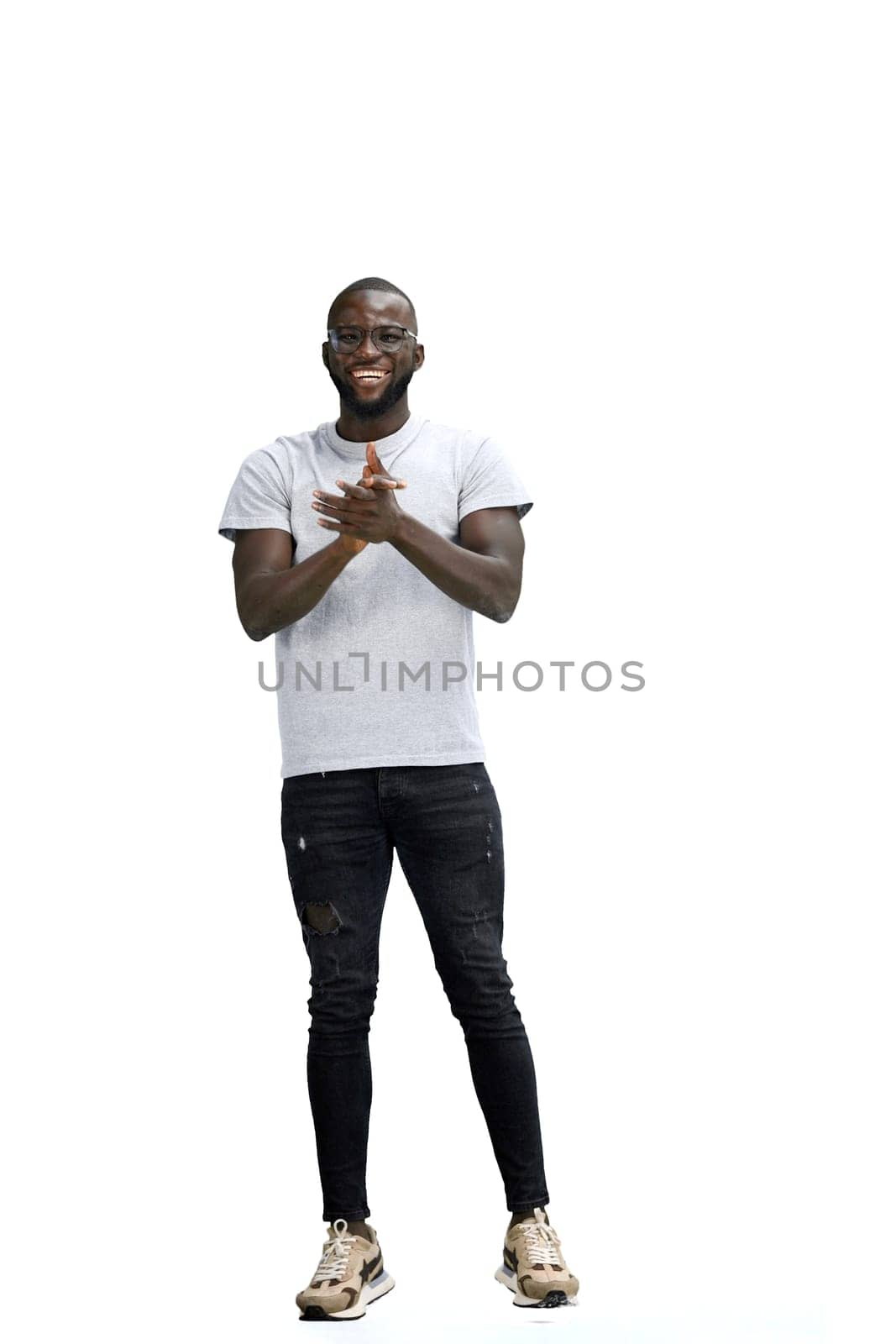 A man, full-length, on a white background, claps.