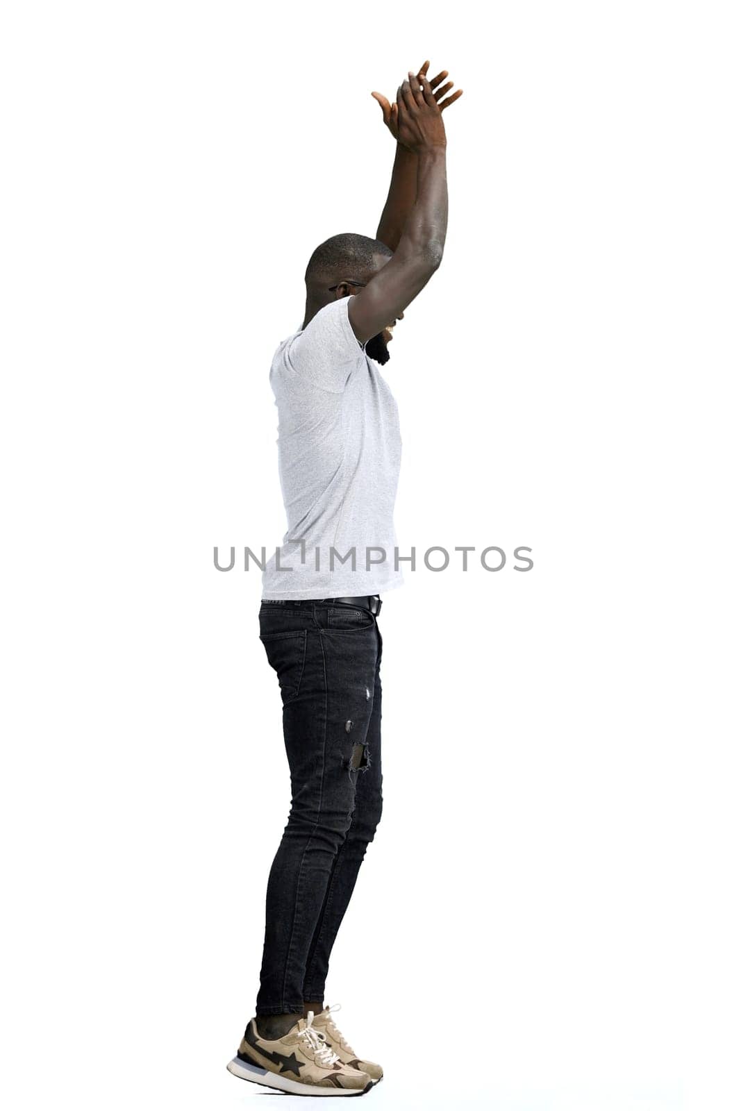 A man, full-length, on a white background, claps.