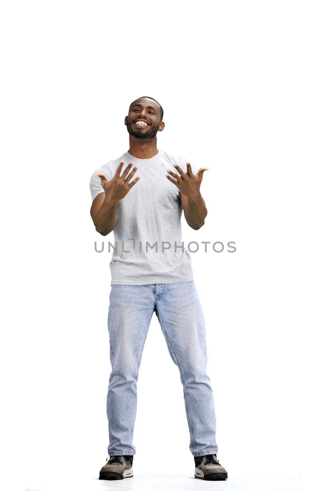 A man, full-length, on a white background, spreads his arms.