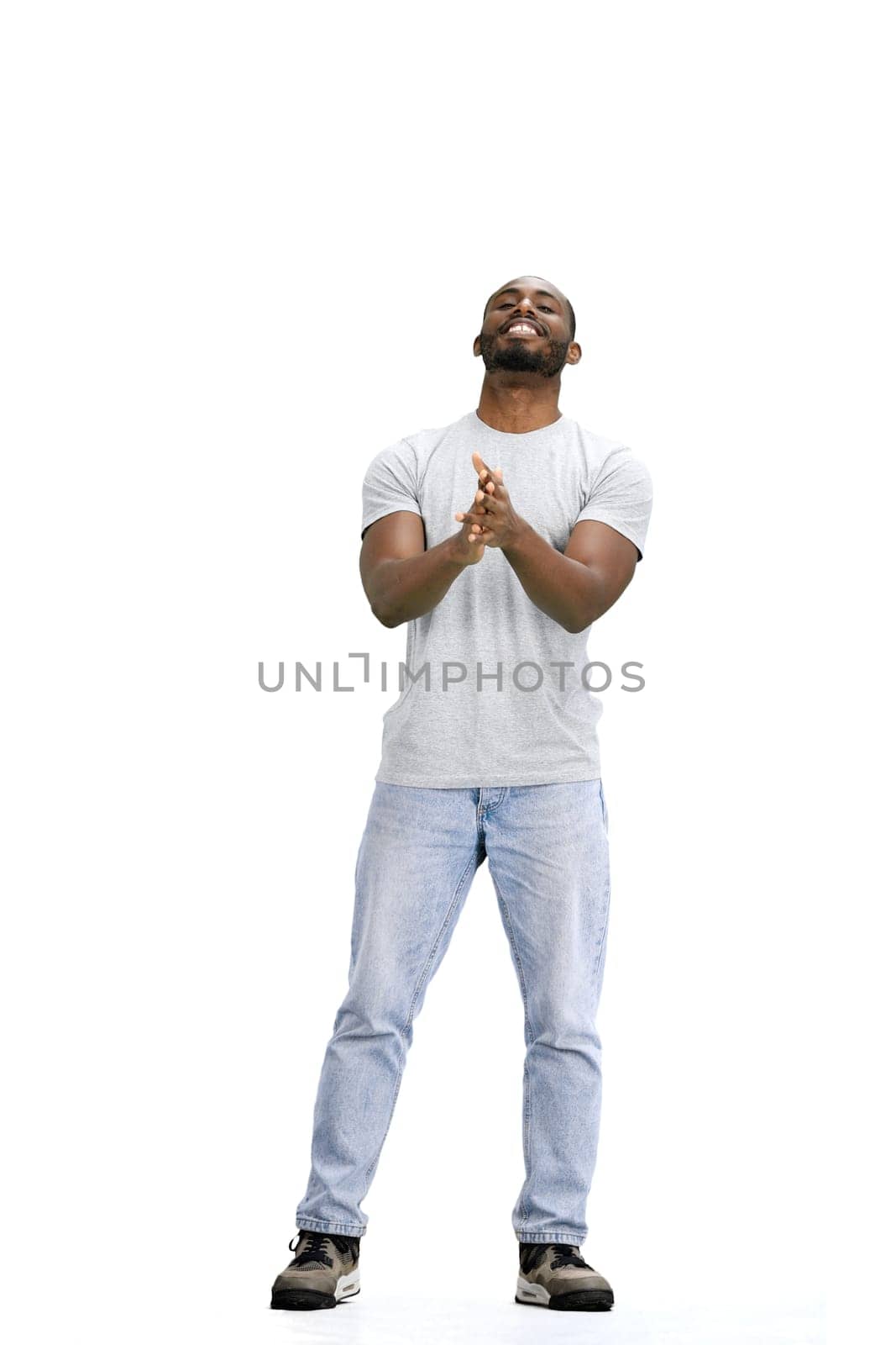 A man, full-length, on a white background, claps.