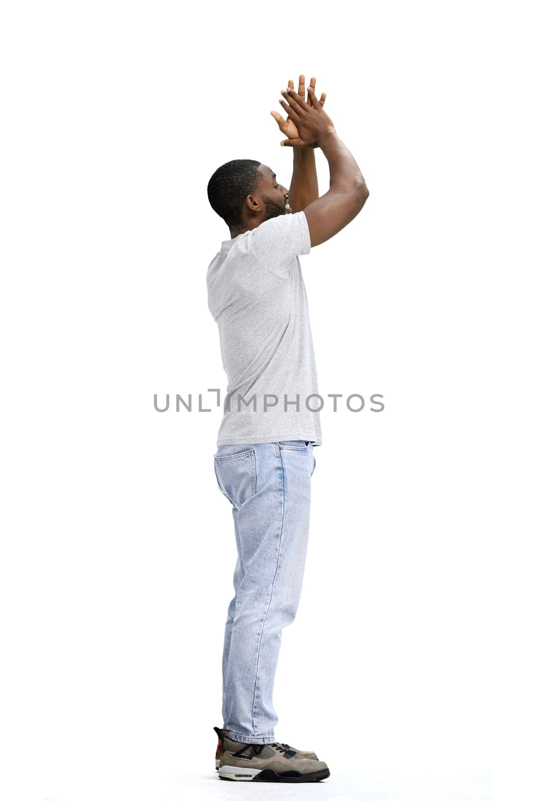 A man, full-length, on a white background, claps.