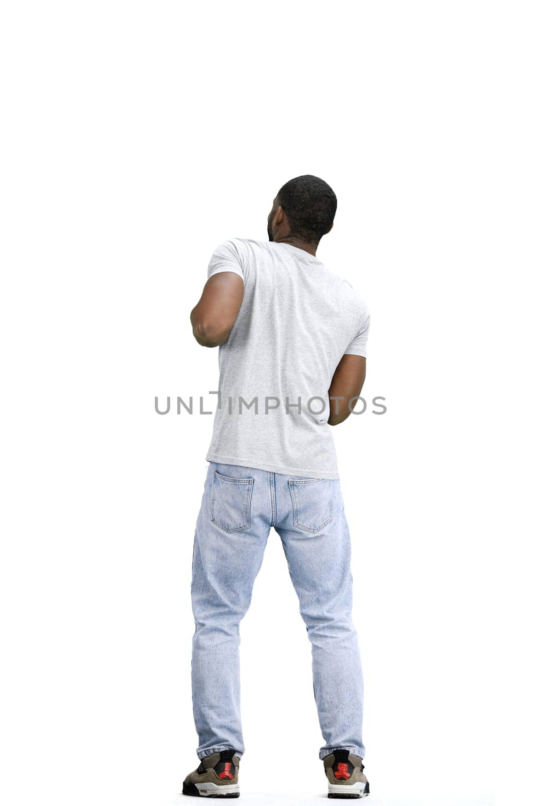 A man, full-length, on a white background, dancing.