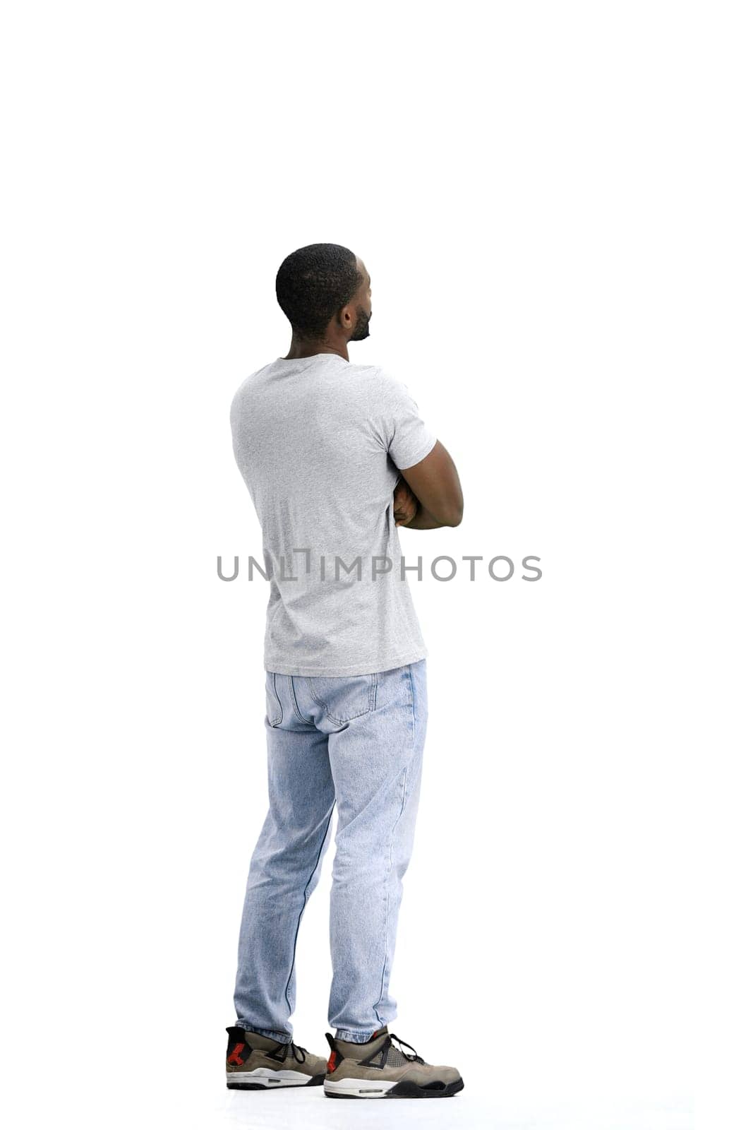 A man, full-length, on a white background, spreads his arms.