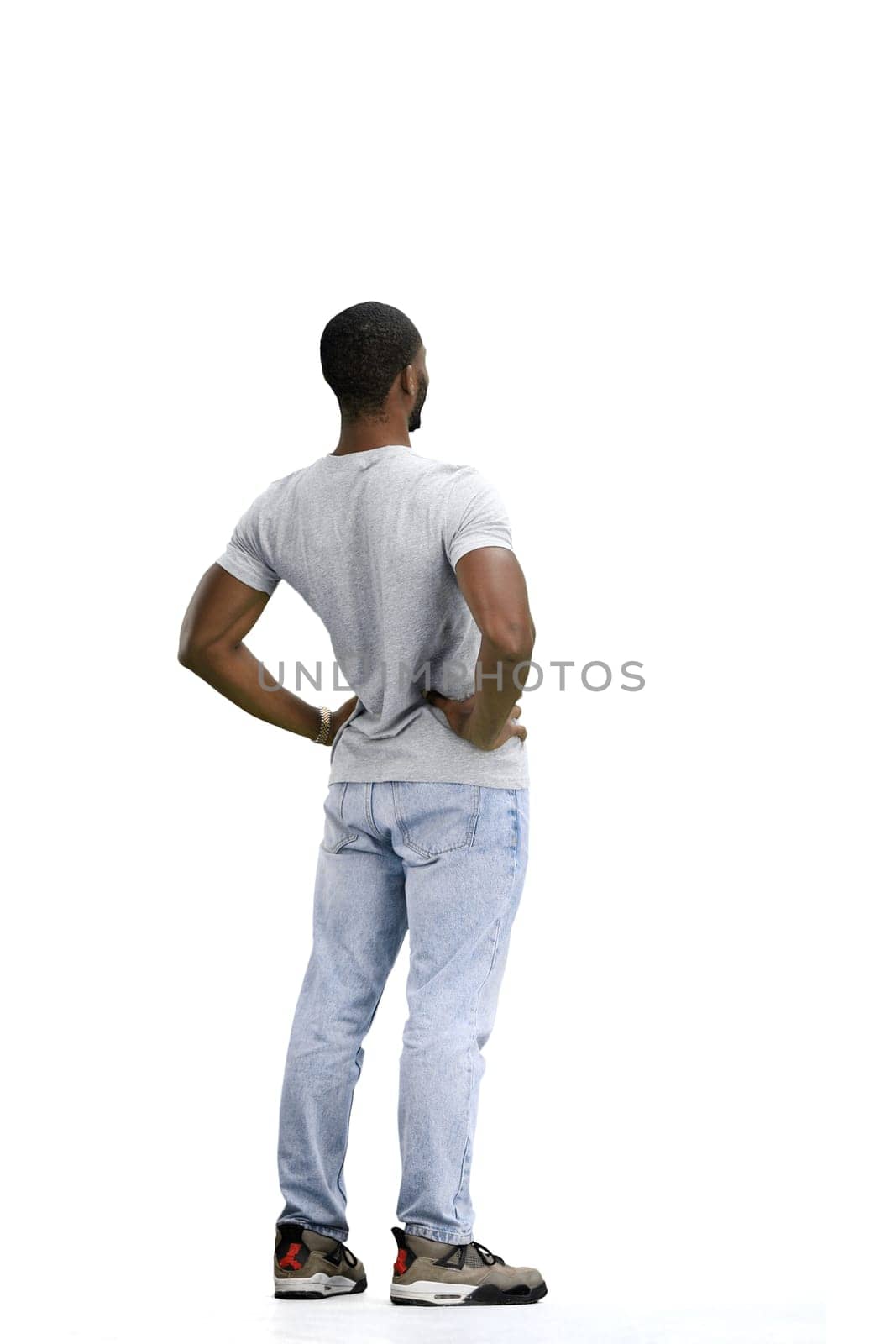 A man, full-length, on a white background, warming up.
